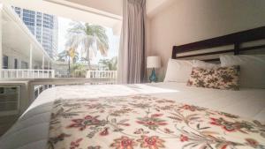 a bedroom with a large bed with a window at Soleado Hotel in Fort Lauderdale