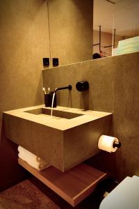 a bathroom with a sink and a roll of toilet paper at the matter Meaningful apartments in Las Palmas de Gran Canaria +53 photos