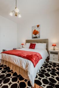 a bedroom with a large bed with a red blanket at City View Gardens I in Funchal