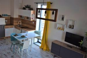 a kitchen with a table and a dining room at Apartament 807 in Warsaw