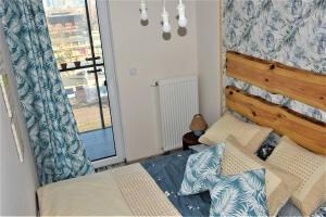 a small bedroom with a bed and a window at Apartament 807 in Warsaw