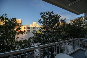 a balcony with trees and a view of a city at MAGNOLIA City Suite in Patra