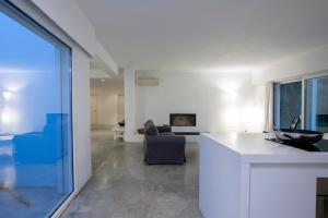 a kitchen and living room with a view of a living room at Villa Mavrades in Sivota