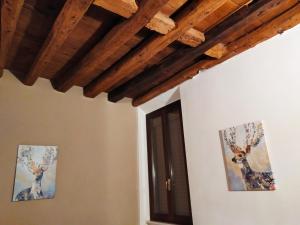 a room with two pictures of deer on the walls at Carducci 49 in Mantova