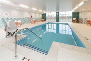 a swimming pool in a large building with a pool at Holiday Inn - Kalamazoo West, an IHG Hotel in Kalamazoo