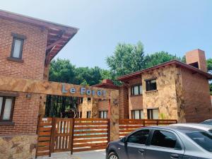 a building with a sign that reads le fork at Departamentos Le Forêt in Mar de Ajó