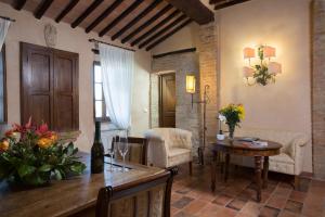 a living room with a table and a dining room at Camere Dentro Il Castello in Monteriggioni