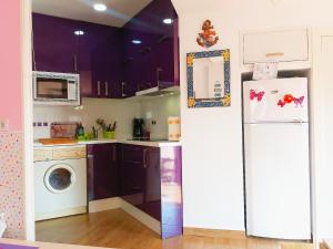 a kitchen with a refrigerator and a washing machine at LOFT DOS MARES- Parking Gratis - 1 Línea de Mediterráneo - Terraza - WIFI in La Manga del Mar Menor