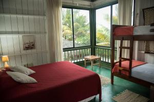 a bedroom with a bed and a large window at La Gondola in Montañita +110 photos