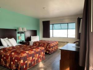 Ein Bett oder Betten in einem Zimmer der Unterkunft Sea Horse Inn and Cottages