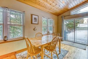 a dining room with a wooden table and chairs at River Song Cabin in Leavenworth