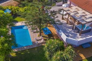 an overhead view of a swimming pool with a pool house at Anna's Brilliant Villa in Ialysos in Ialysos