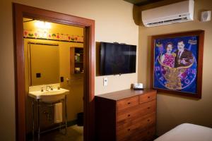a bathroom with a sink and a tv on the wall at McMenamins Elks Temple in Tacoma
