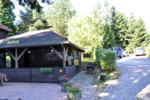 a small building with flowers in front of it at Ośrodek Bajka 3 in Łagów