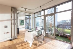 a dining room with a table and large windows at Saint Anns in London