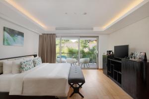 a bedroom with a large bed and a balcony at Double - Six, Luxury Hotel - Seminyak in Seminyak