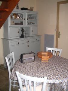 a dining room with a table and a dresser at A L'Ombre Du Figuier in Saint-Thois +20 photos