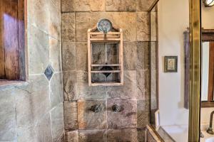 a bathroom with a shower with a stone wall at Romantic Ridgetop Escape with Hot Tub Near Mendocino in Albion