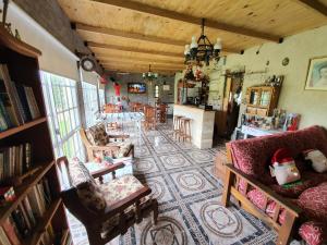 a living room with a couch and chairs and a table at Posada La Pausa - Solo para Adultos in Miramar