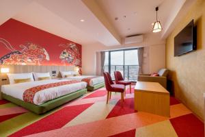 a hotel room with two beds and a tv at RESI STAY Nishijin in Kyoto