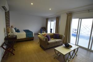 uma sala de estar com um sofá e uma cama em Thunderbird Resorts - Poro Point em São Fernando