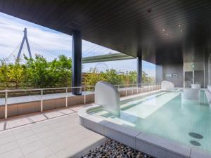 a swimming pool on the roof of a building at LIBER HOTEL Osaka in Osaka