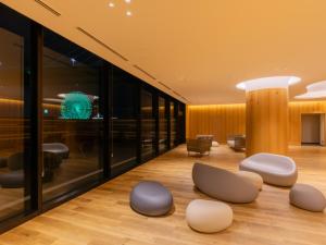 a lobby with circular chairs on the floor at LIBER HOTEL AT UNIVERSAL STUDIOS JAPAN in Osaka