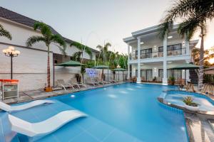 a large blue swimming pool in front of a building at Villa Caribe in Phu Quoc