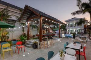 a patio with tables and chairs and a pool at Villa Caribe in Phu Quoc