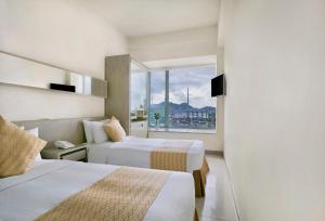Giường trong phòng chung tại Rambler Oasis Hotel