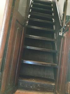 a set of stairs in a building at Kunnampath Heritage Nalukettu in Trichūr