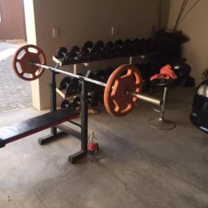 a gym with a bunch of equipment in a room at Man Cave Suite in Swakopmund