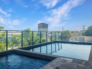 a swimming pool on top of a building at Direct Collective - Rhythm on Beach in Maroochydore