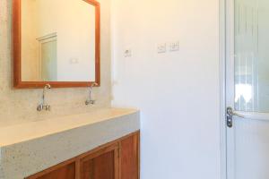 a bathroom with a sink and a mirror at Hostel Bukit Sangcure in Nusa Penida