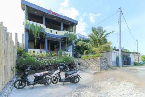 motorcycles parked in front of a house at Hostel Bukit Sangcure in Nusa Penida