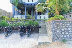 motorcycles parked in front of a building at Hostel Bukit Sangcure in Nusa Penida