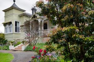 an old house with a garden in front of it at Anabel's of Scottsdale in Scottsdale