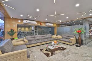 a living room with couches and a table in a building at HOTEL LE GRAND in Surat