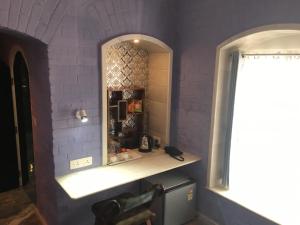 a bathroom with a white counter and a mirror at Rose Heritage Home in Varanasi