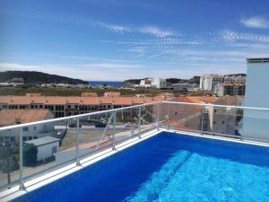 a balcony with a swimming pool on top of a building at Beautiful Apartment in S o Martinho do Porto with Balcony in São Martinho do Porto