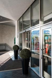 two potted plants sitting on the side of a building at Ibis Kazan Hotel in Kazan