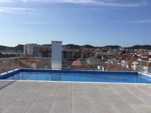 a swimming pool on the roof of a building at Beautiful Apartment in S o Martinho do Porto with Balcony in São Martinho do Porto