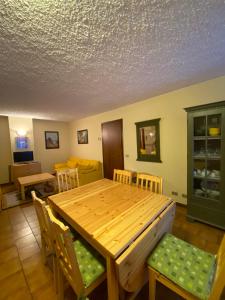 a dining room with a wooden table and chairs at DOWNTOWN MADESIMO in Madesimo