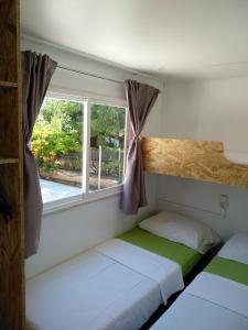 a small bedroom with a bed and a window at Villa Jadranka Pakostane in Pakoštane