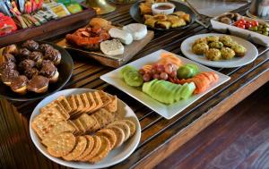 a buffet with plates of different types of food at Rhino Walking Safaris in Skukuza