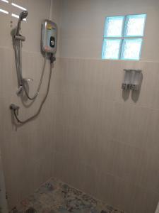 a shower in a bathroom with a window at Mook Paradise Bungalow in Koh Mook