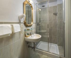a bathroom with a sink, toilet and bathtub at Hotel Villa Carlotta in Florence