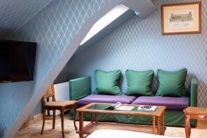a living room with a couch and a table at Elysées Hôtel in Paris