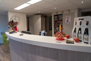 an office with a counter with bottles of wine at VVF Normandie Veules-les-Roses in Veules-les-Roses
