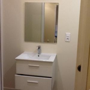 a bathroom with a white sink and a mirror at Le Clos Domenat 3 in Brive-la-Gaillarde